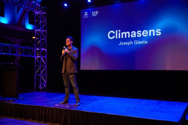 Man on stage speaking at Melbourne Accelerator Program event