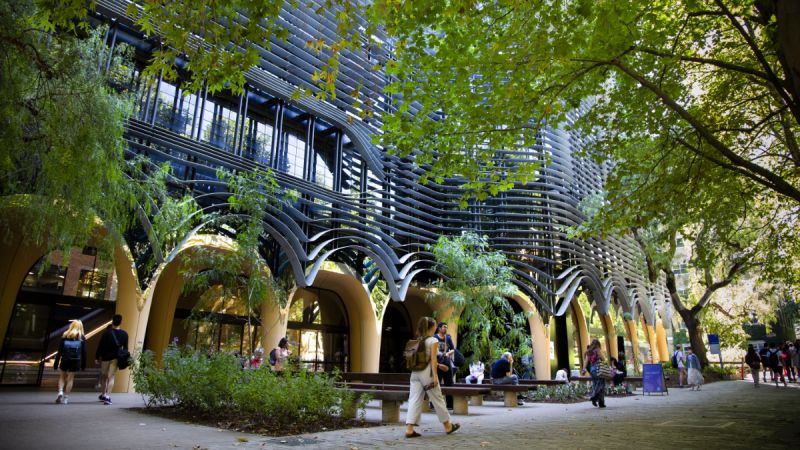 Students stroll on the leafy Parkville campus of the University of Melbourne