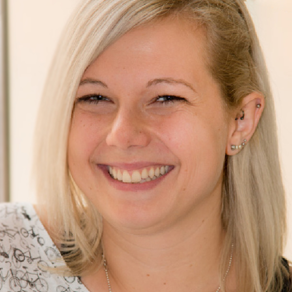 Susie Seibt is a white woman with bright blonde hair and a wide smile