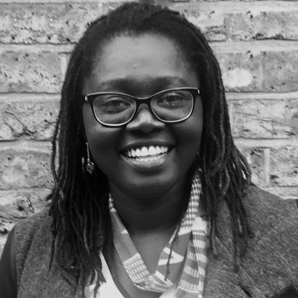 Franka Vaughan is a Black woman with long dreadlocs and a bright smile