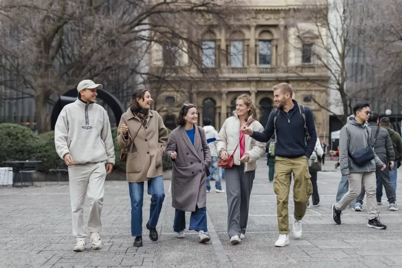 A group of young people walking together on the university campus