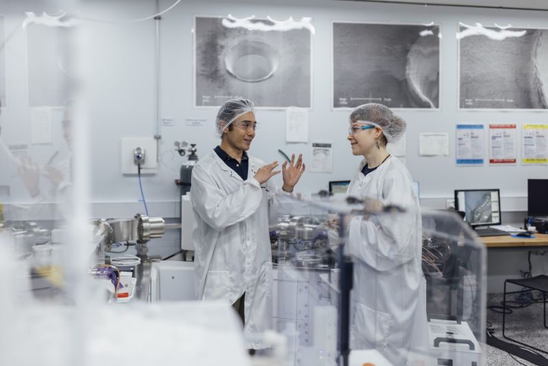 Three people talking in a laboratory