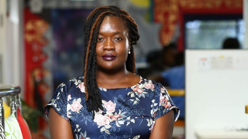 Kagonya Awori, a black woman with braided hair, regards the camera solemnly