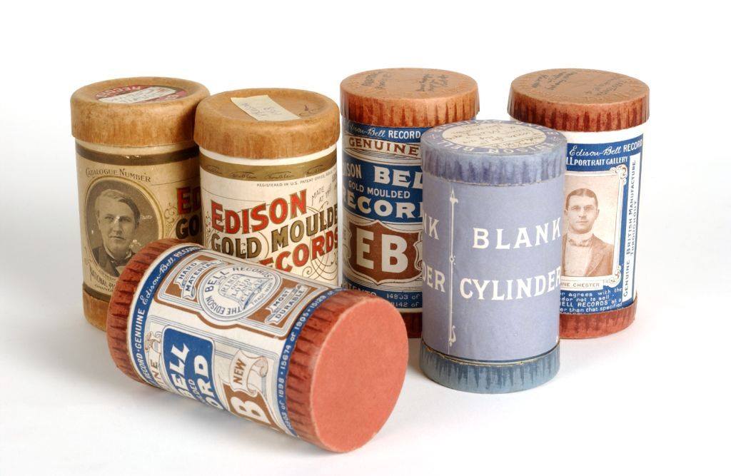 Five early 20th century wax cylinders side by side against a white background.
